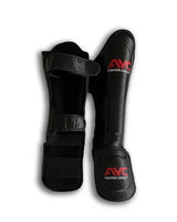 Black martial arts shin guards with red fighter logo and adjustable straps, front and back view