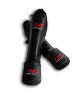 Black martial arts shin guards with red AYC Fighter Choice logo on a white background
