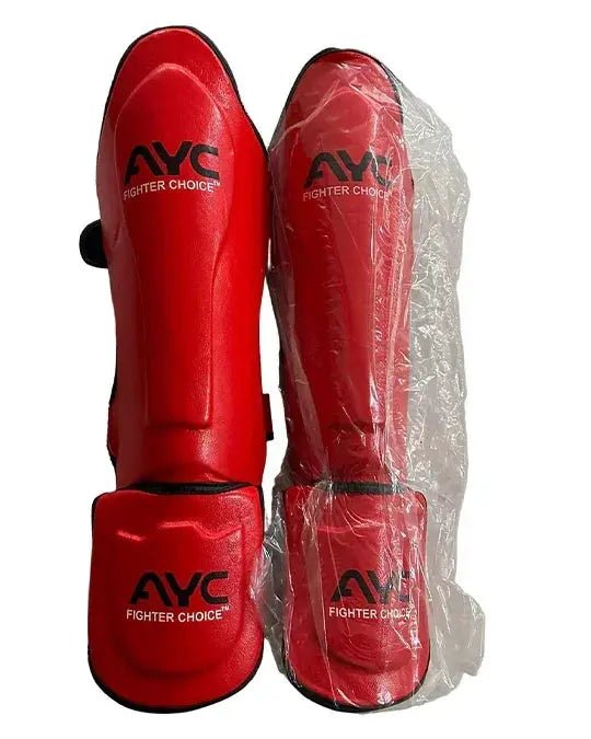 Red martial arts shin guards with foot protection, AYC Fighter Choice logo, one wrapped in plastic