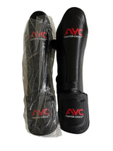 Black shin guards with red AYC Fighter Choice logo, one in packaging, for martial arts protection